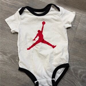 Jordan Infant Bodysuit in White with Red Graphic and Black Edges